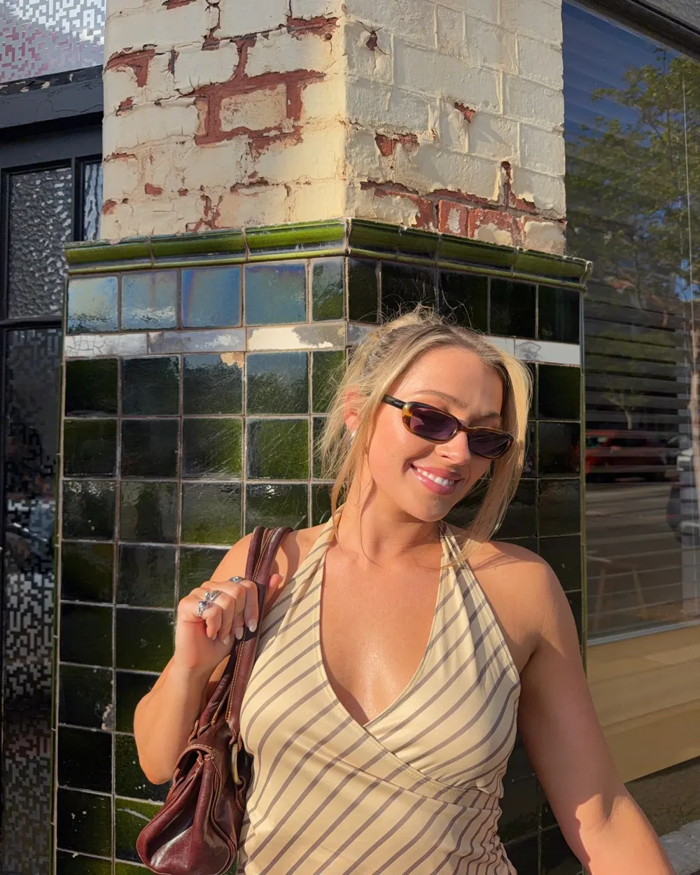 Georgia (@geodale), Outlet co-founder, smiling in the afternoon sun